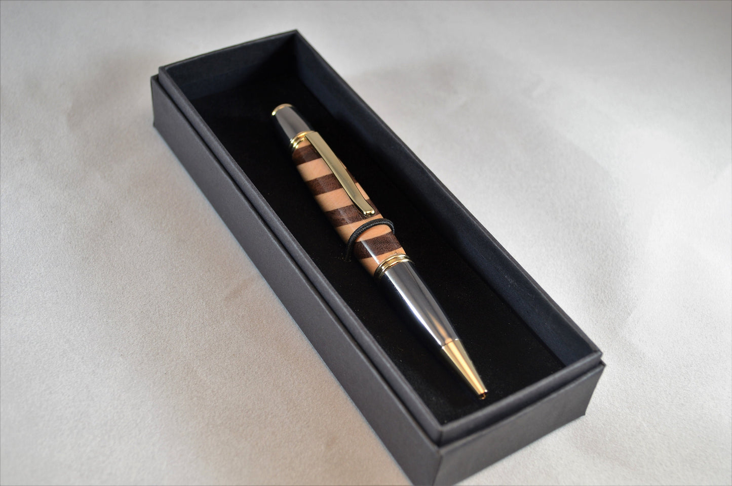 One of a Kind Classic Twist Pen in 22k Gold and Gunmetal Finish with Handcrafted Maple and Walnut.