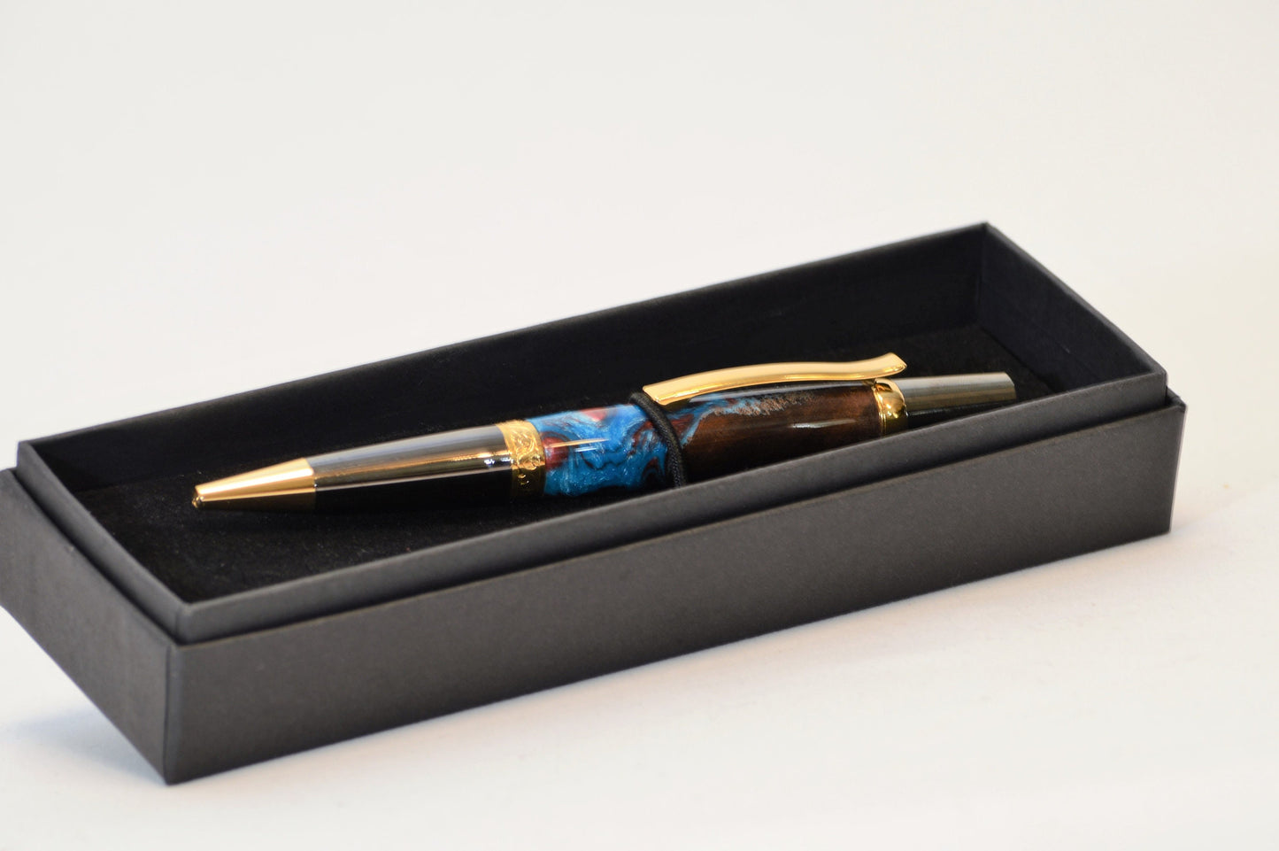 One of a Kind Elegant Twist Pen in Gold Titanium and Black Titanium with Handcrafted Acrylic and North Georgia Walnut Body.