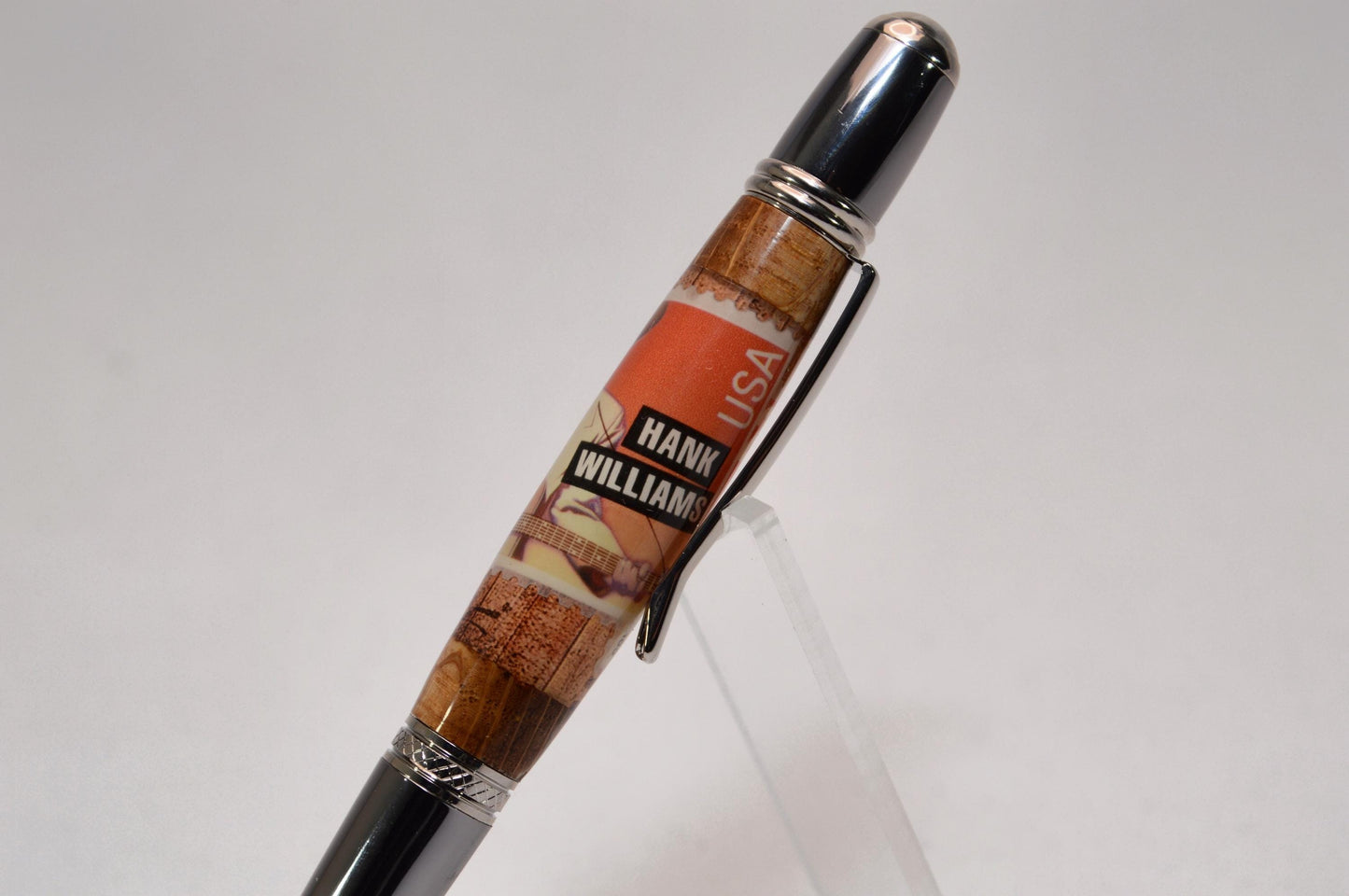 Handcrafted Pen Featuring a Hank Williams Postage Stamp and Wood from Hank Williams Bosier City, LA home cast in acrylic.