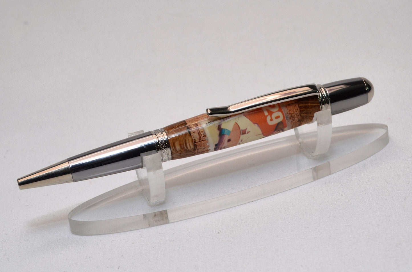 Handcrafted Pen Featuring a Hank Williams Postage Stamp and Wood from Hank Williams Bosier City, LA home cast in acrylic.