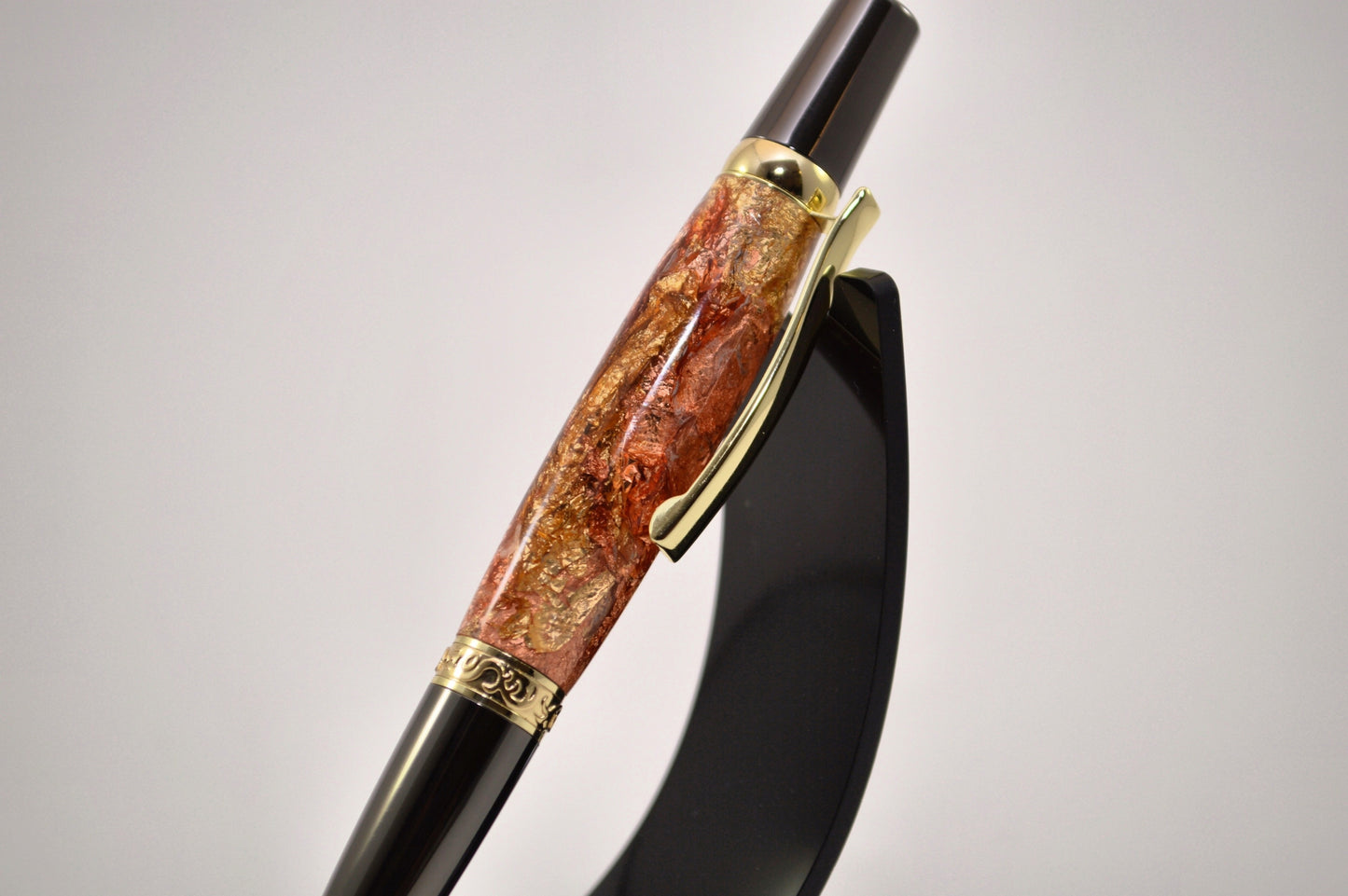Elegant Gold and Gunmetal Twist Pen with Copper And Gold Gilding Cast in Clear Acrylic