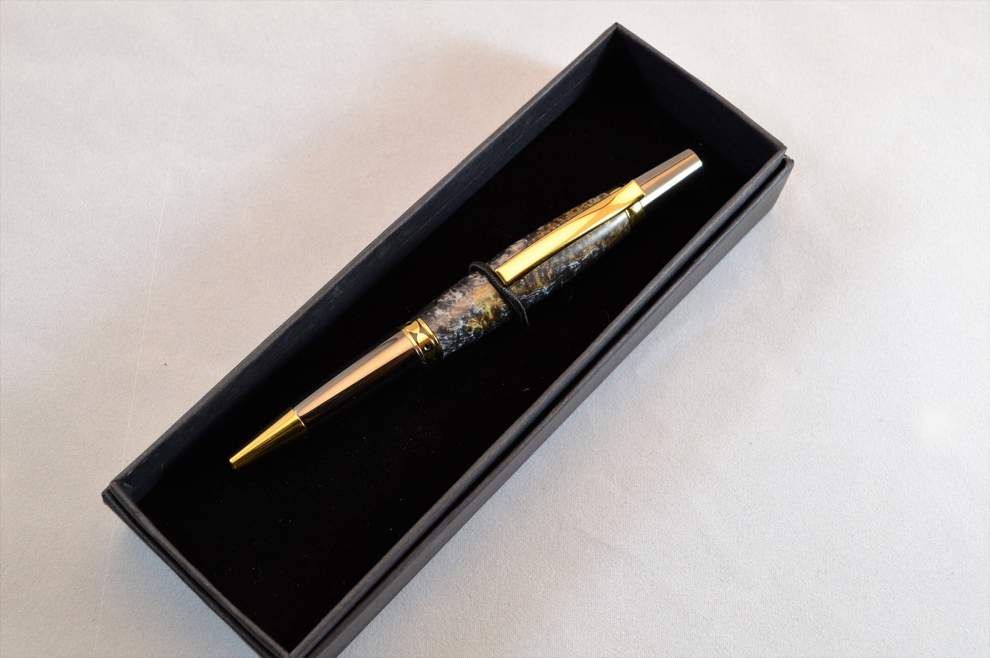 One of a Kind Twist Pen in Gold Titanium and Black Titanium with Handcrafted Acrylic Body.