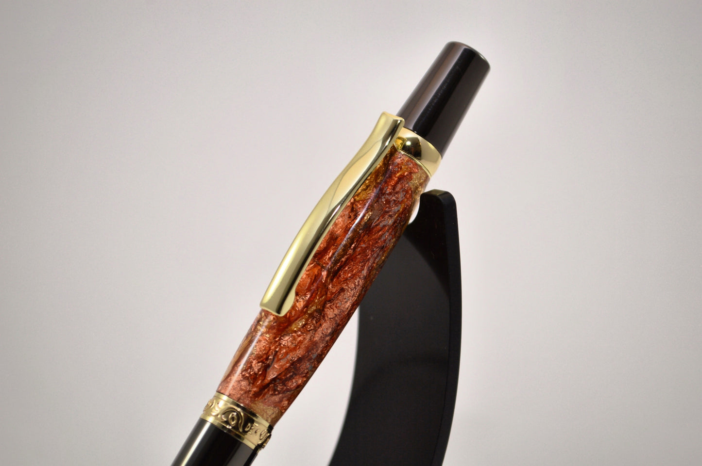 Elegant Gold and Gunmetal Twist Pen with Copper And Gold Gilding Cast in Clear Acrylic
