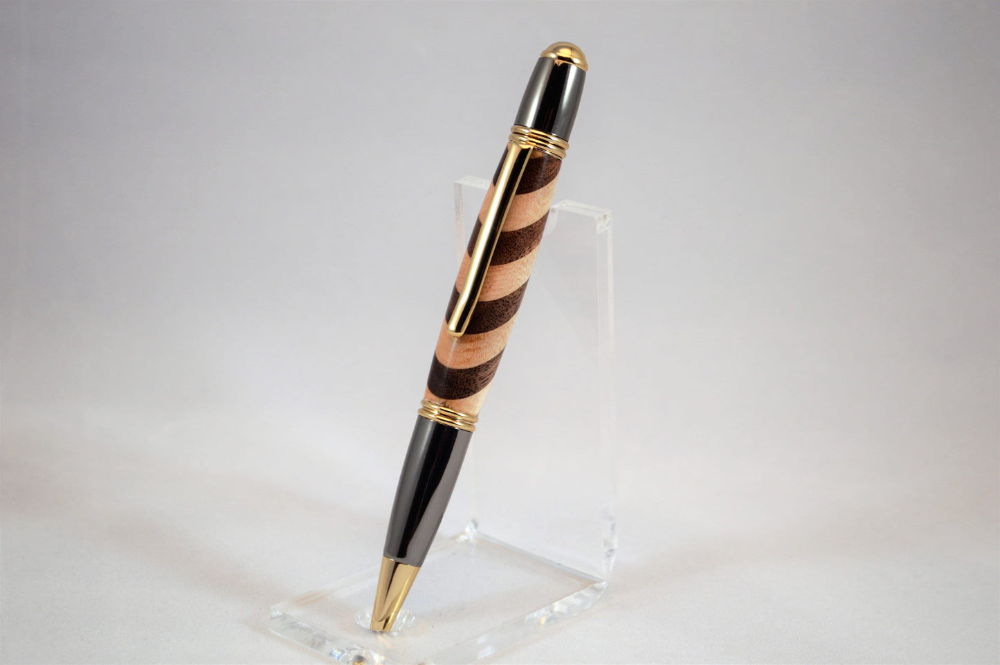 One of a Kind Classic Twist Pen in 22k Gold and Gunmetal Finish with Handcrafted Maple and Walnut.
