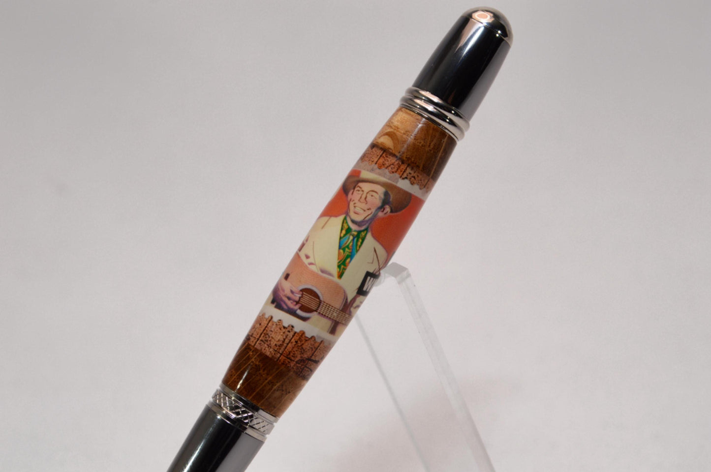 Handcrafted Pen Featuring a Hank Williams Postage Stamp and Wood from Hank Williams Bosier City, LA home cast in acrylic.
