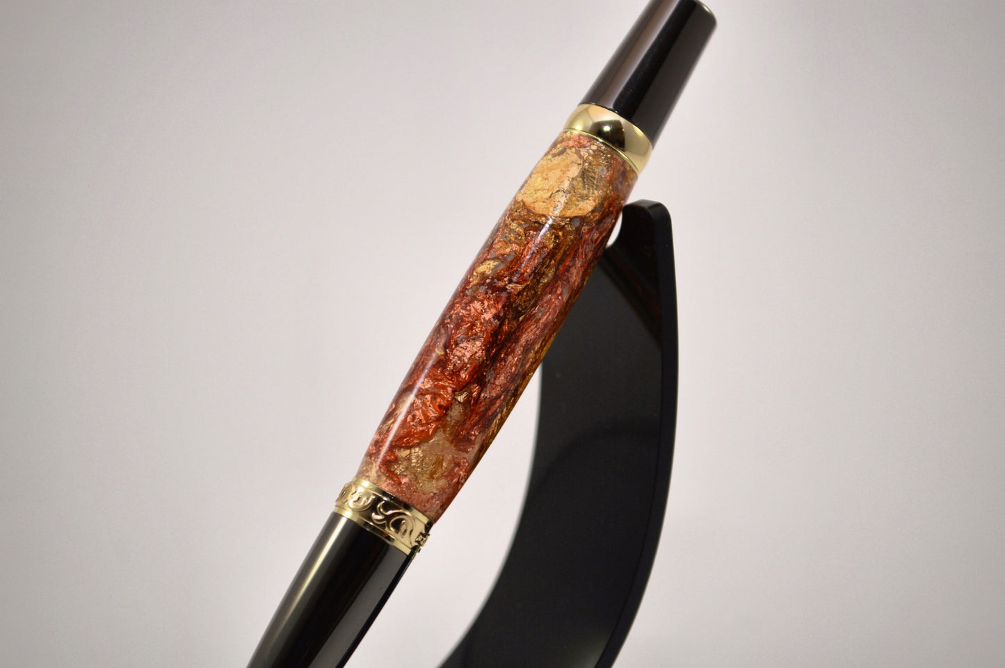 Elegant Gold and Gunmetal Twist Pen with Copper And Gold Gilding Cast in Clear Acrylic